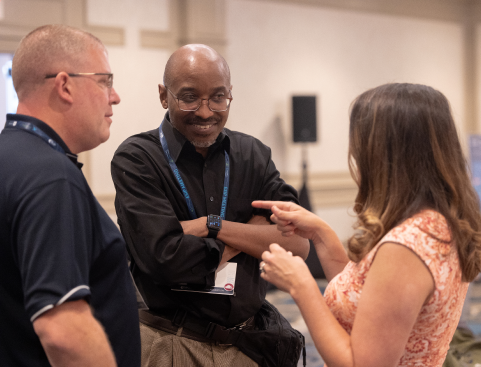 two men and a woman talking