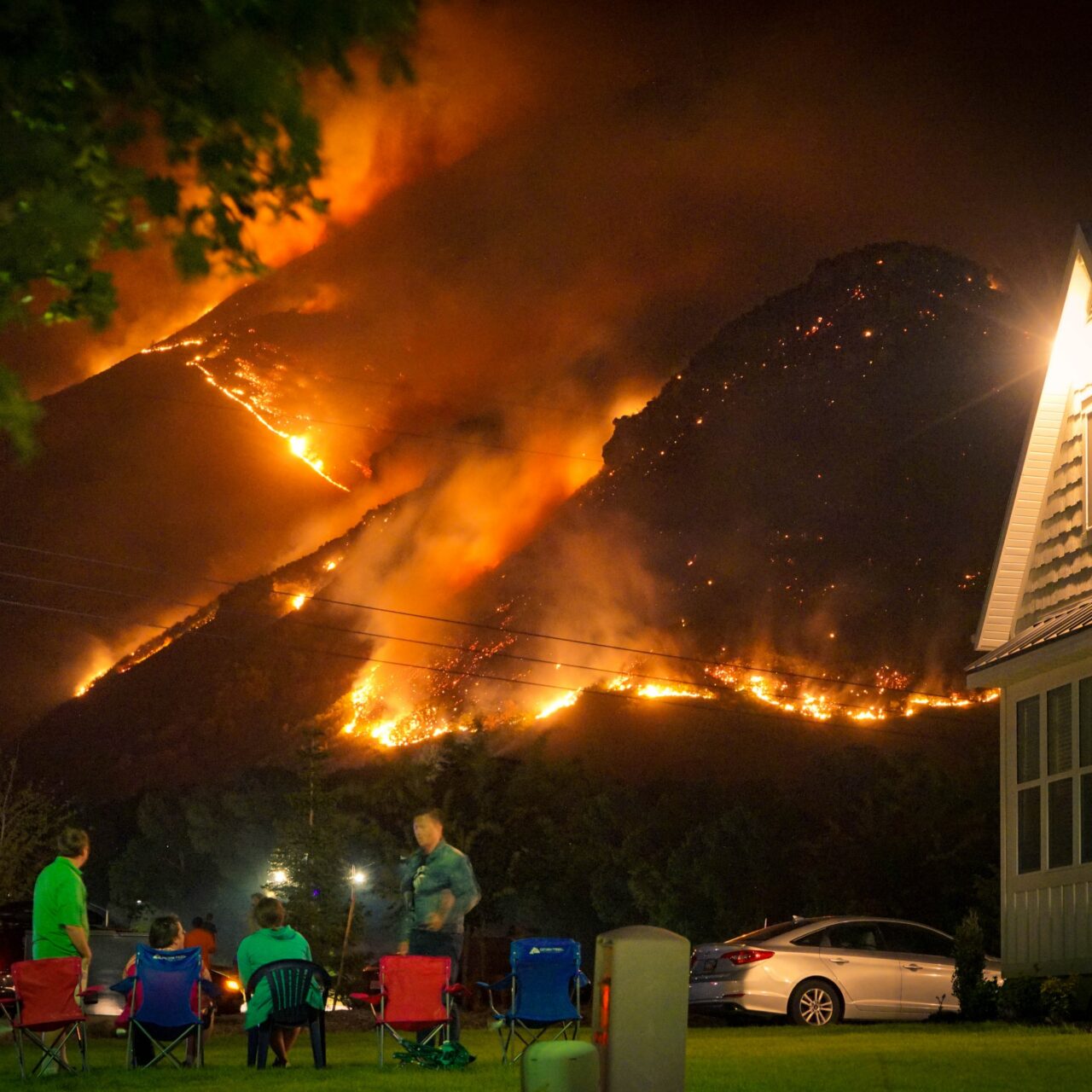 people watching a raging wildfire