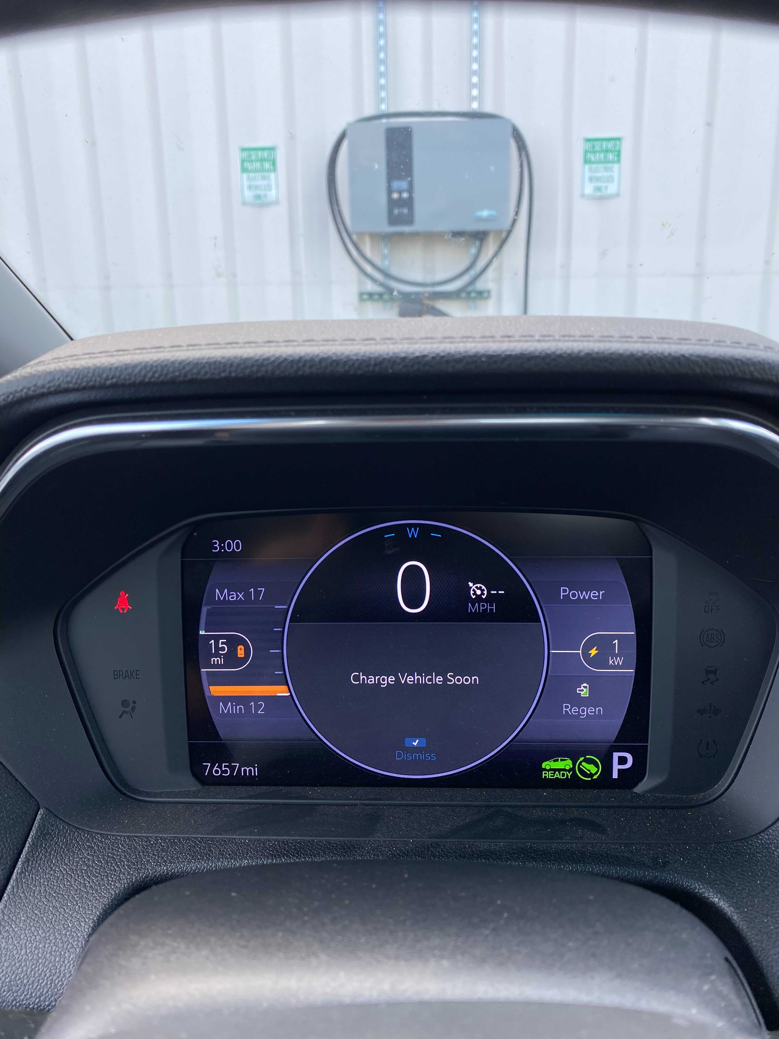 Photo of inside console of a Chevy Bolt; the battery reads “15 miles”