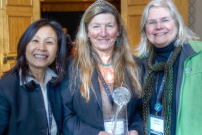 three women holding a trophy