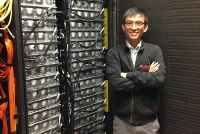 man next to a super computer