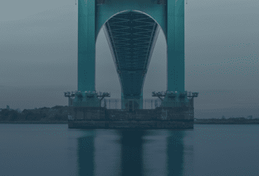 Image of a bridge with a sky and water horizon; meant to encourage Open Science practices.