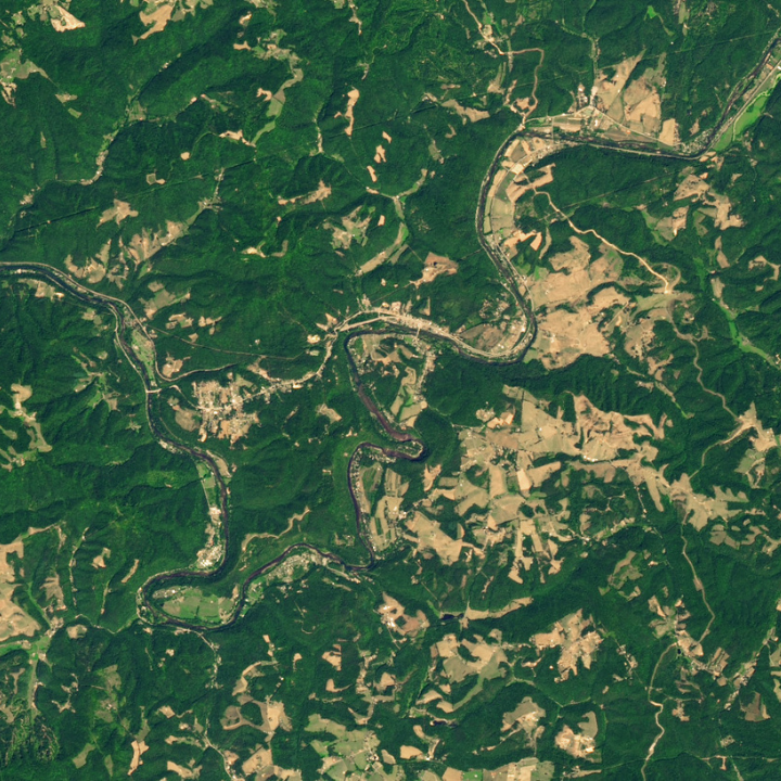 satellite image of a flooded river, forests, and mountains in North Carolina