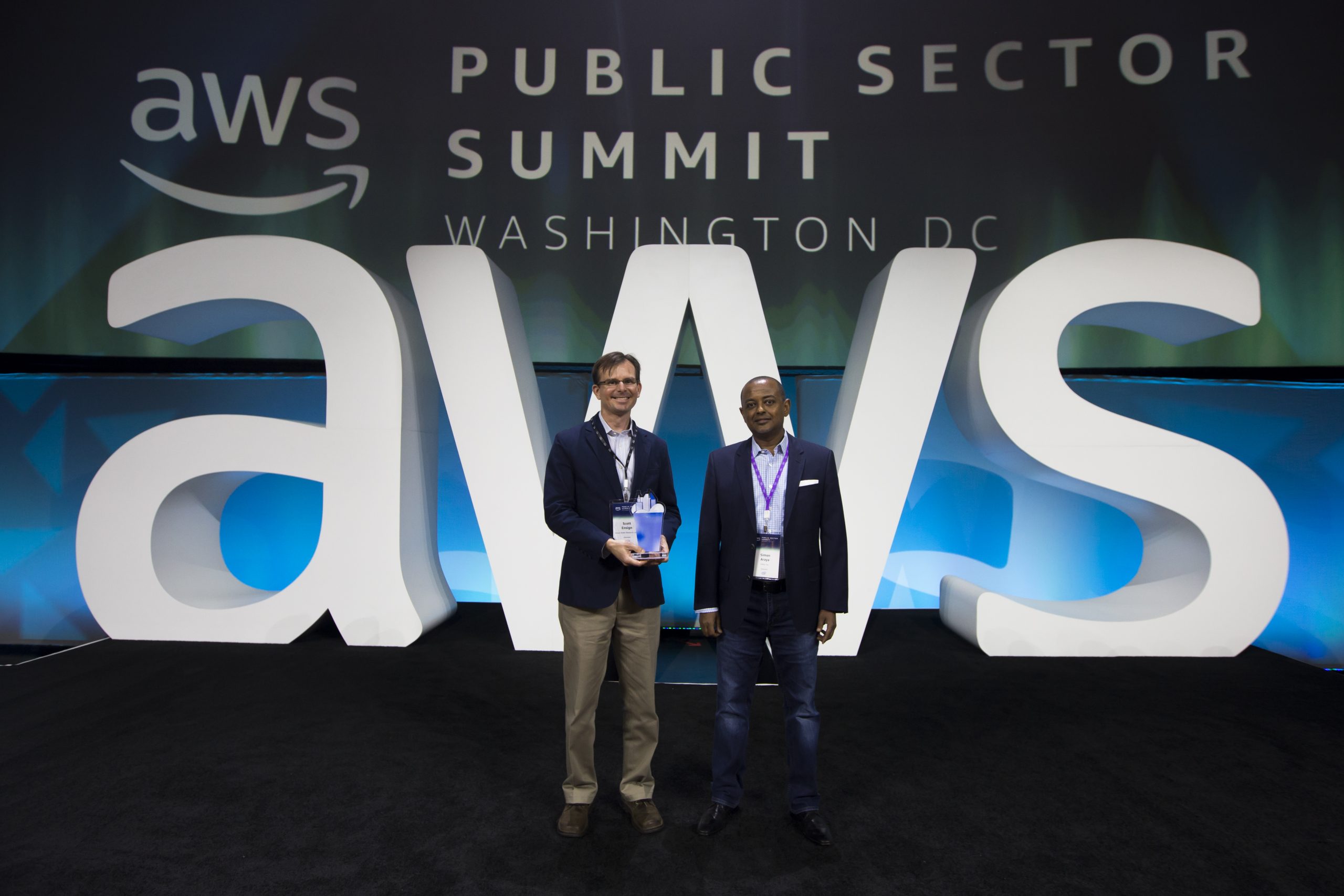Award recipients stand on stage at the Amazon Web Services Public Sector Summit.